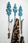 Blue fleur-de-lis wall hooks with scarf and bag