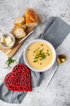 Cast iron heart trivet with soup and bread